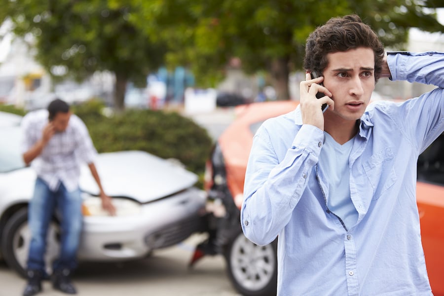 Teenager on phone near car accident 